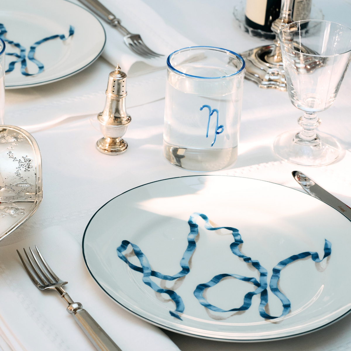 A set of four blue ribbon dinner plates. Harper’s Bazaar Best Hostess Gifts for Dinner Parties, Movie Nights, and More. These ribbon-adorned dinner plates can transform even an easy meal into something fit for a downtown It-girl. With three different colors to choose from, you can find the perfect option for home design lovers.