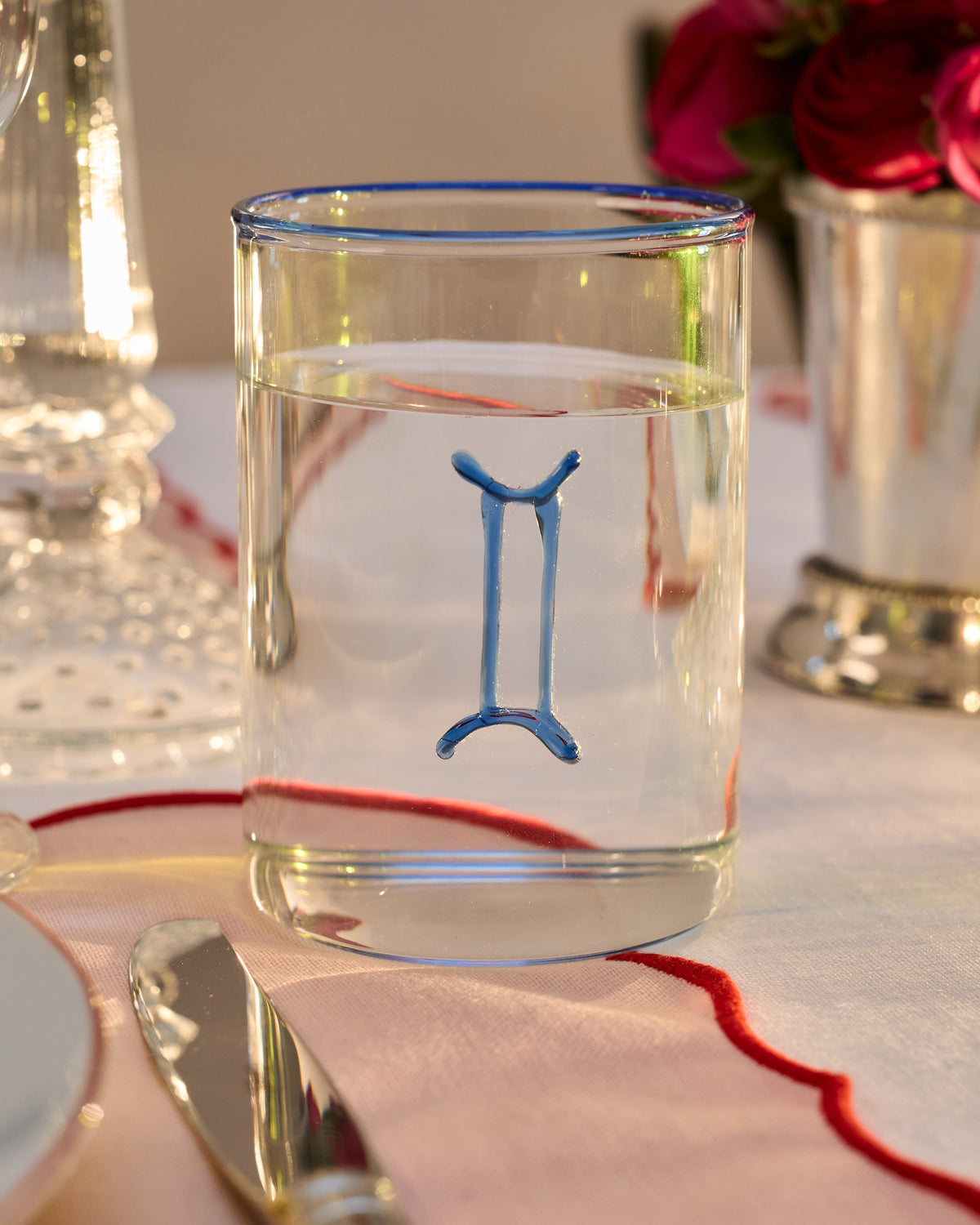 GEMINI LOWBALL GLASS ON A BEAUTIFUL LINEN TABLE MAT ON AN ELEGANT 
