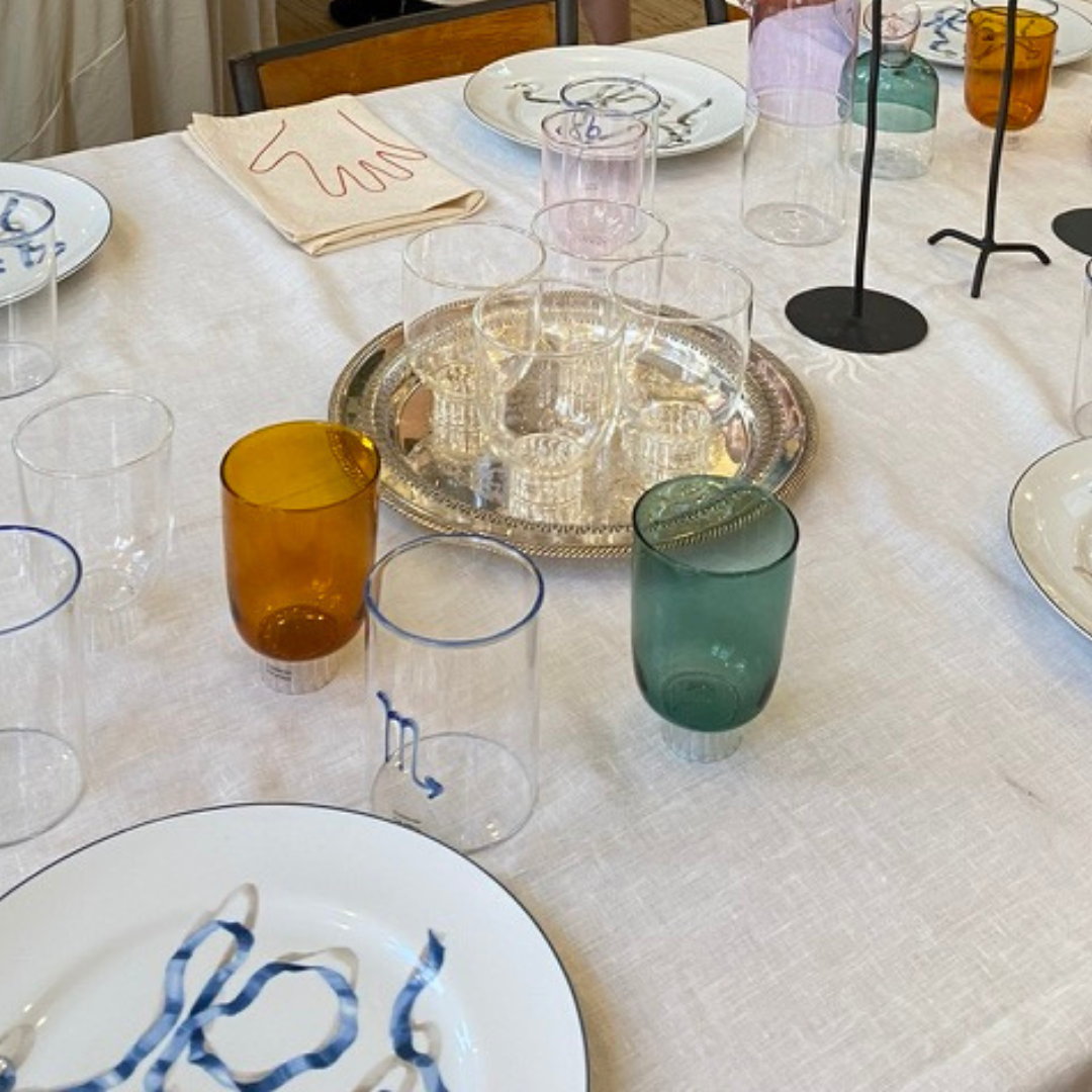 elegant tableware and colored wine stemware