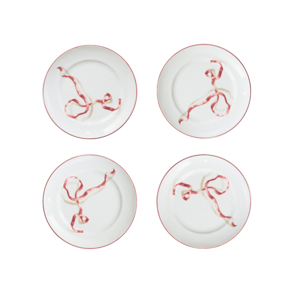 A set of four ribbon dessert plates in pink. Harper’s Bazaar Best Hostess Gifts for Dinner Parties, Movie Nights, and More. These ribbon-adorned dinner plates can transform even an easy meal into something fit for a downtown It-girl. With three different colors to choose from, you can find the perfect option for home design lovers.