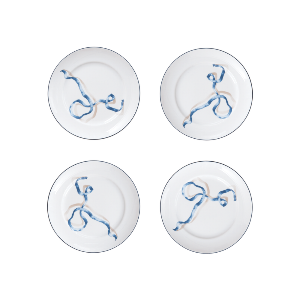 Set of Four Ribbon Desset Plates in Blue. We’re willing to bet your favorite foodie has never seen dinner plates quite like these. Designed by artist and designer Adam Charlap Hyman for Sprezz’s holiday collection, these plates feature a 3D-like ribbon design inspired by 17th- and 18th-century paintings. These fun plates are available in two sizes and three colors.