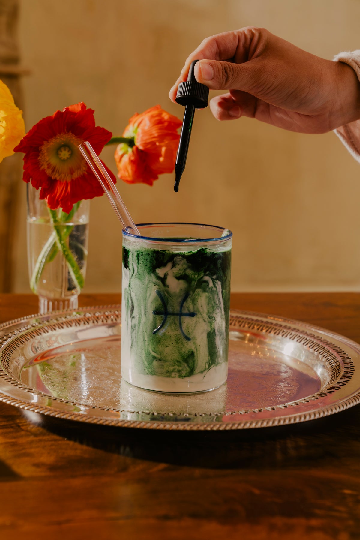 A marbled green and white smoothie in a clear glass adorned with a blue glass. Vibrant orange poppies in a vase in the background add a splash of color and a lively contrast to the earthy tones of the drink. The best fancy glass tumblers. But even if you don’t make these your everyday drinking glasses, you might pick up a two-tumbler set for special occasions or to have on hand as a last-minute host gift. 