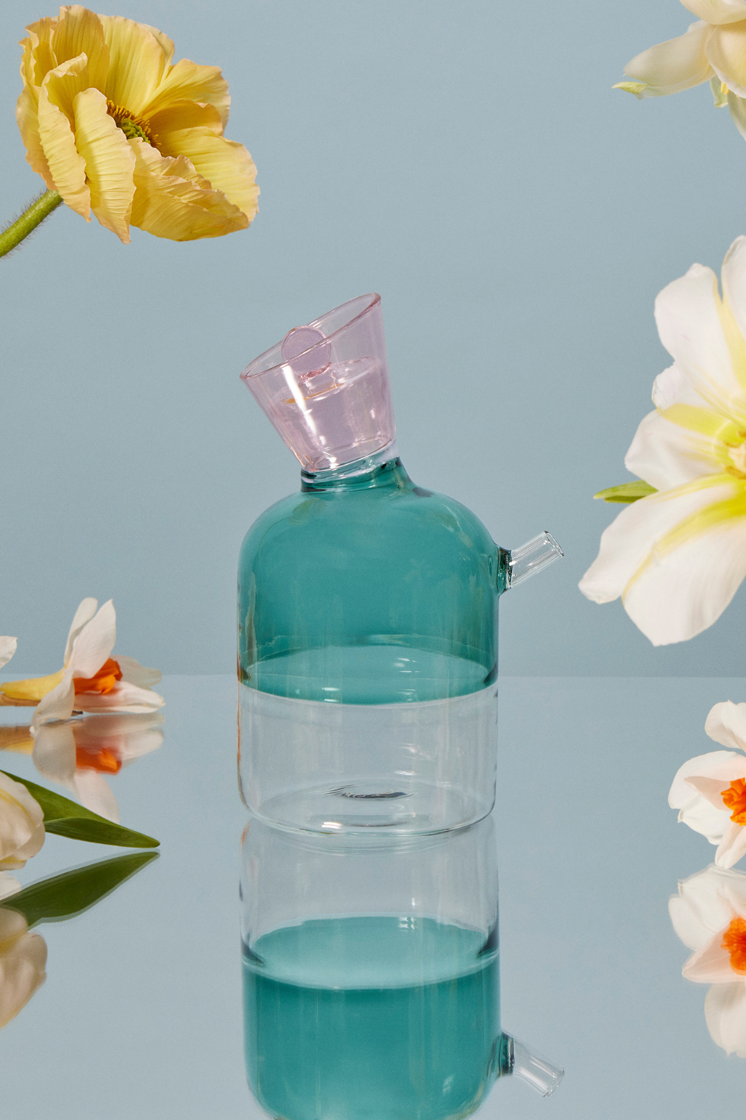 Sprezz hand-blown dishwasher safe olive oil bottle emerald green.  Crafted from sturdy hand-blown borosilicate glass, the modern color blocking on this joyful piece makes it stylish enough to leave on display (perhaps with a few florals placed inside).